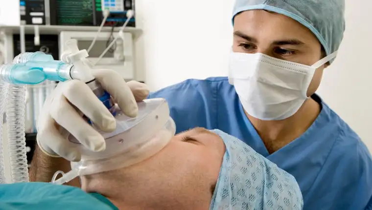 anaesthetist administering to a patient during surgery