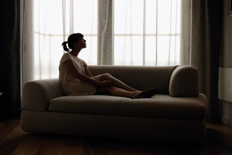Woman lying down on sofa