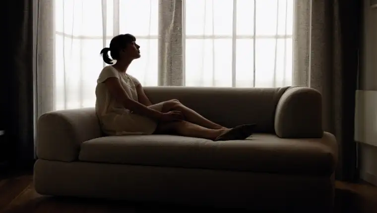 Woman lying down on sofa