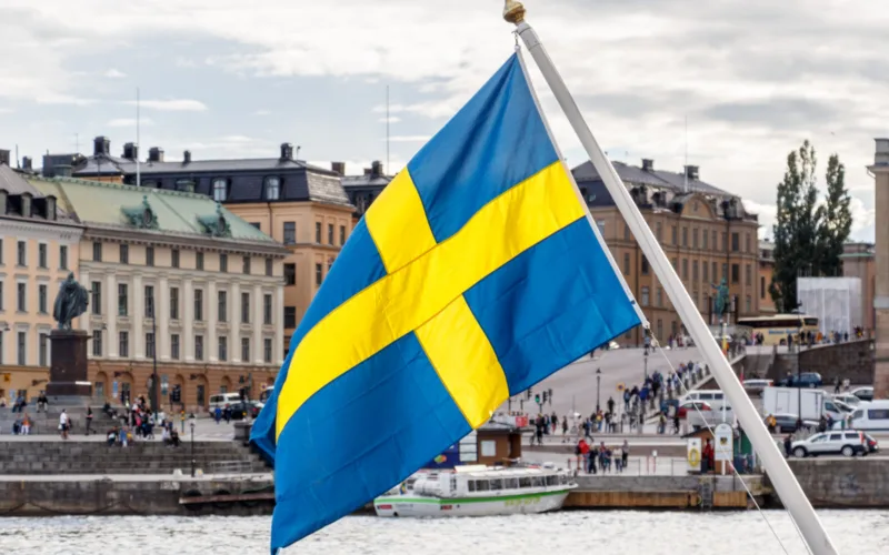 Sweden flag and Stockholm old town Gamla Stan in background