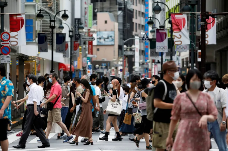 FILE PHOTO: People walk at a crossing in Shibuya shopping area, amid the coronavirus disease (COVID-19) pandemic, in Tokyo