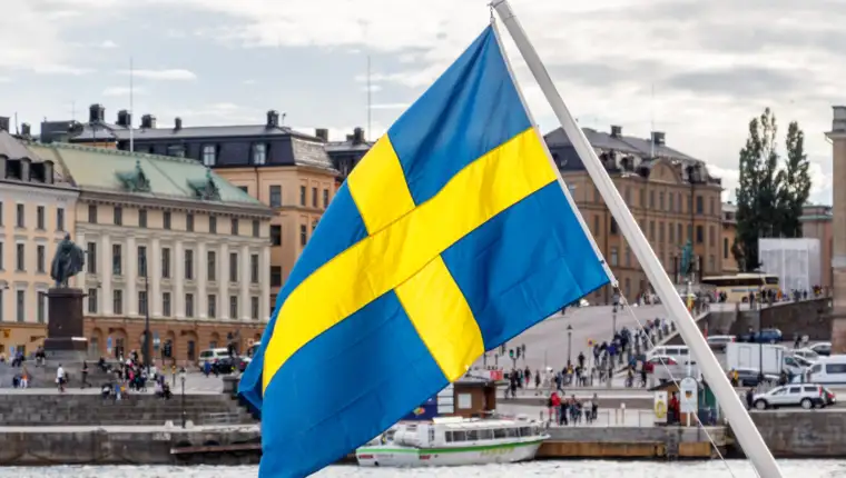 Sweden flag and Stockholm old town Gamla Stan in background