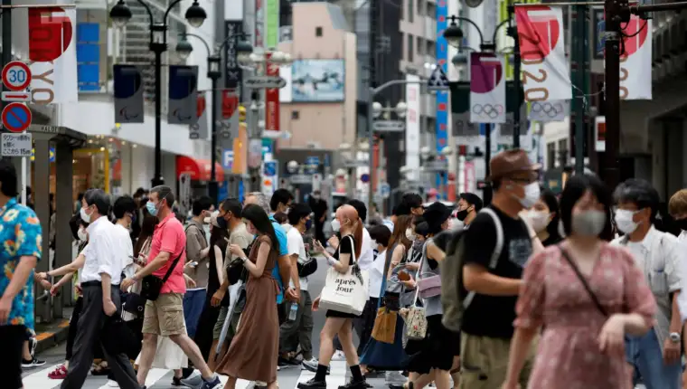 FILE PHOTO: People walk at a crossing in Shibuya shopping area, amid the coronavirus disease (COVID-19) pandemic, in Tokyo