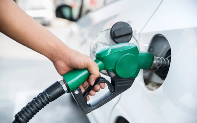 Handle fuel nozzle to refuel. Vehicle fueling facility.