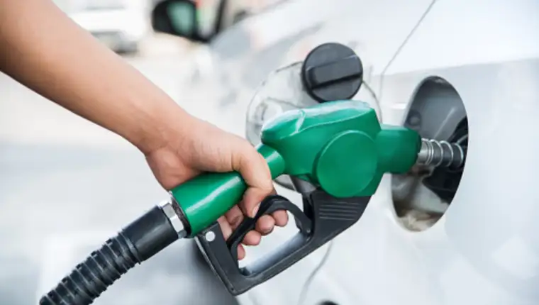 Handle fuel nozzle to refuel. Vehicle fueling facility.