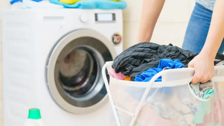 Woman holding laundry basket full of clothes