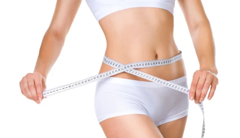 Woman measuring her waistline. Perfect Slim Body