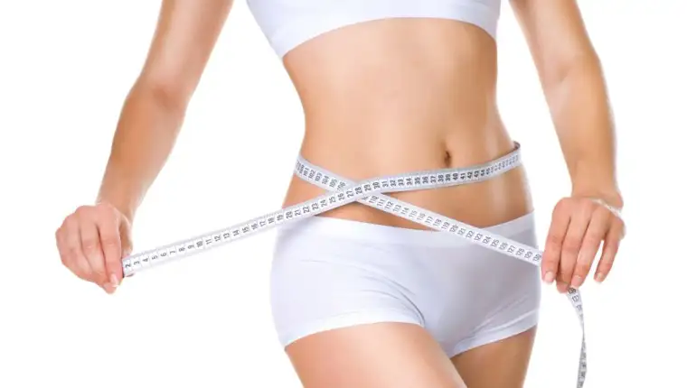 Woman measuring her waistline. Perfect Slim Body