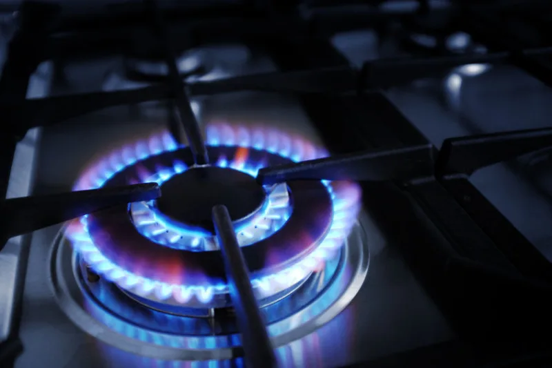 37575898 - closeup on gas stove burner with blue flames