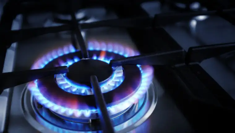 37575898 - closeup on gas stove burner with blue flames