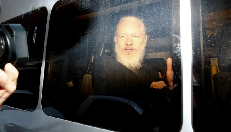 FILE PHOTO: WikiLeaks founder Julian Assange is seen in a police van, after he was arrested by British police, in London