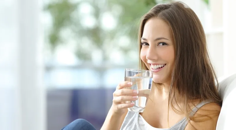 Girl drinking water at home