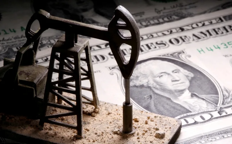 FILE PHOTO: A 3D-printed oil pump jack is placed on dollar banknotes in this illustration picture