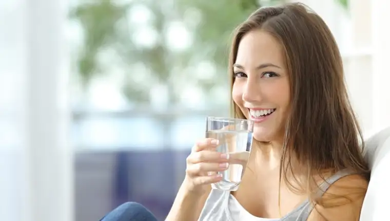 Girl drinking water at home