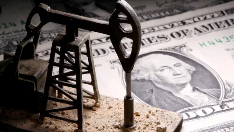 FILE PHOTO: A 3D-printed oil pump jack is placed on dollar banknotes in this illustration picture