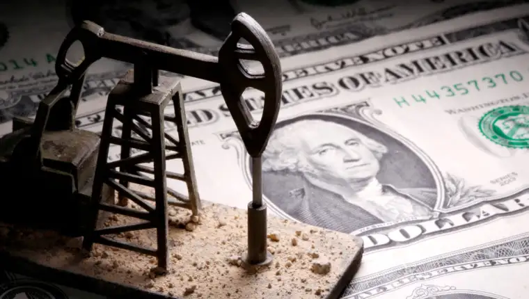 FILE PHOTO: A 3D-printed oil pump jack is placed on dollar banknotes in this illustration picture