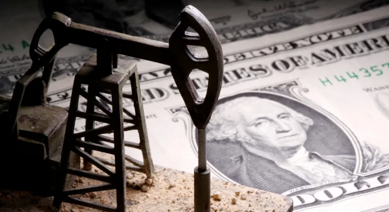 FILE PHOTO: A 3D-printed oil pump jack is placed on dollar banknotes in this illustration picture