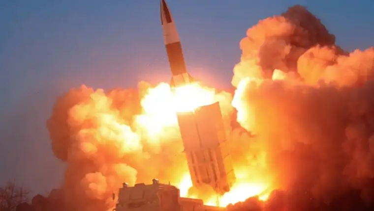 FILE PHOTO: North Korean leader Kim Jong Un observes the firing of suspected missiles