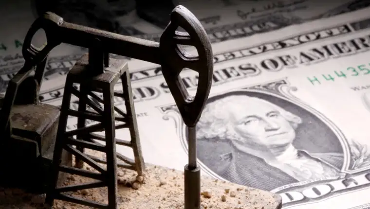 FILE PHOTO: A 3D-printed oil pump jack is placed on dollar banknotes in this illustration picture