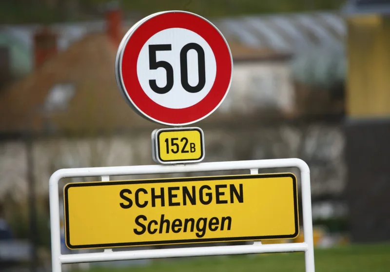 A street sign marks the beginning of the small Luxembourg village of Schengen