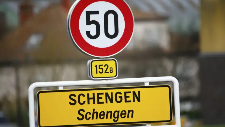 A street sign marks the beginning of the small Luxembourg village of Schengen