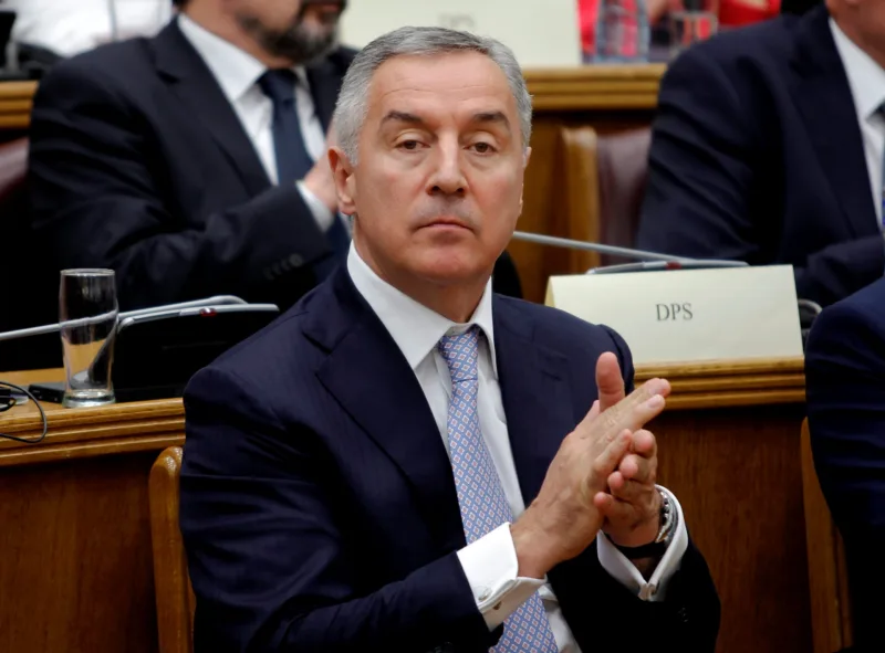President of a ruling Democratic Party of Socialist (DPS), former prime minister and president of Montenegro, Milo Djukanovic applauds during a parliament discussion on NATO membership agreement in Cetinje