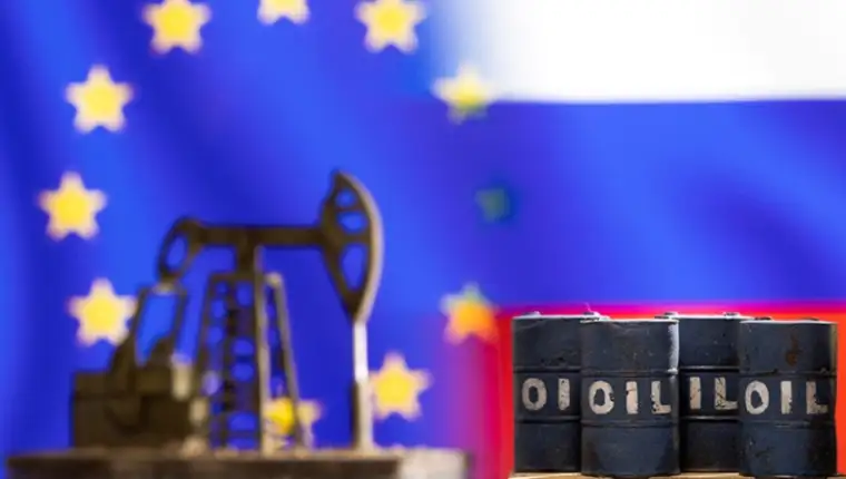 FILE PHOTO: Illustration shows models of oil barrels and a pump jack in front of U.S. and Russia flag colors