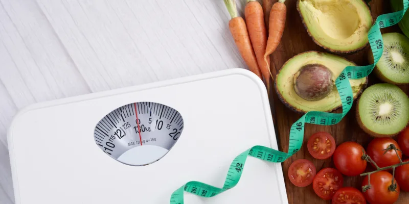 Weight loss scale with centimeter. Diet concept. Healthy food background. Food photography different fruits and vegetables. concept slimming diet fresh vegetables. top view.