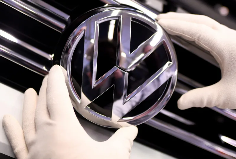 FILE PHOTO: A Volkswagen logo is pictured in a production line at the Volkswagen plant in Wolfsburg