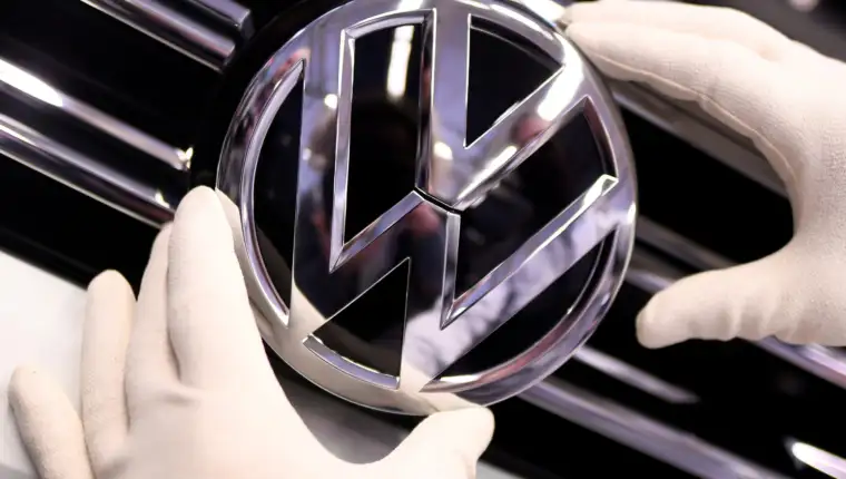 FILE PHOTO: A Volkswagen logo is pictured in a production line at the Volkswagen plant in Wolfsburg