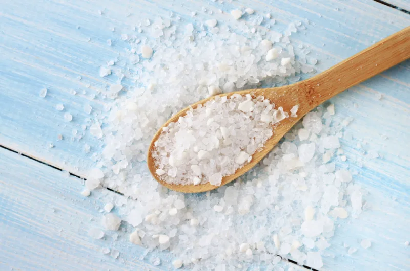 Sea salt on wooden table wooden spoon