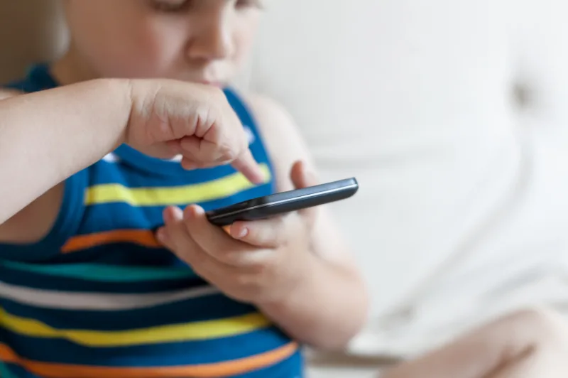 Boy playing a game on smart phone