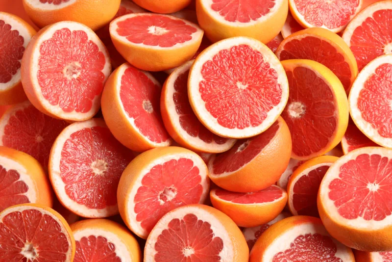 Many,Sliced,Fresh,Grapefruits,As,Background,,Top,View