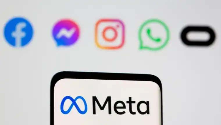 FILE PHOTO: Facebook's new rebrand logo Meta is seen on smartpone in front of displayed logo of Facebook, Messenger, Intagram, Whatsapp, Oculus in this illustration taken