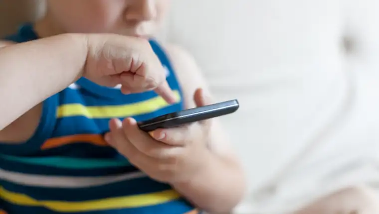 Boy playing a game on smart phone