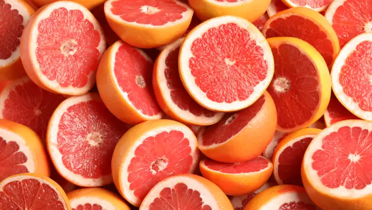 Many,Sliced,Fresh,Grapefruits,As,Background,,Top,View