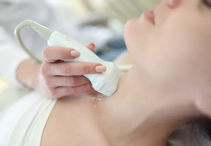Doctor,Conducting,Ultrasound,Of,Thyroid,Gland,To,Woman,Patient,In