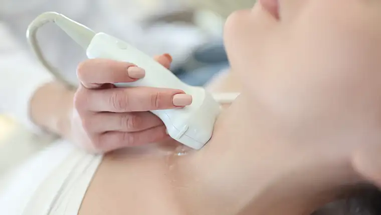 Doctor,Conducting,Ultrasound,Of,Thyroid,Gland,To,Woman,Patient,In