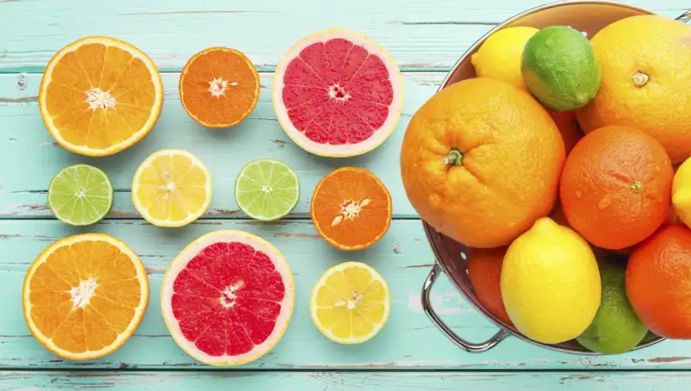 Citrus fruits in retro colander.