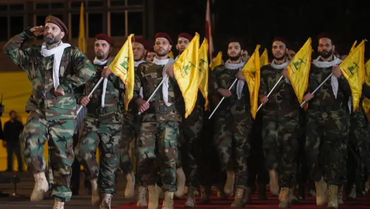 Members of Hezbollah march with party's flags during a rally marking al-Quds Day, (Jerusalem Day) in Beirut