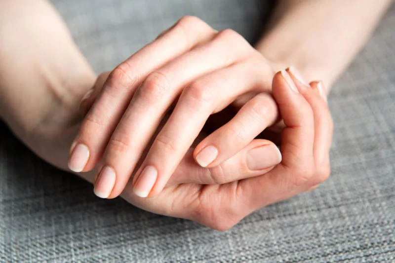 Female,Hands,On,Gray,Background