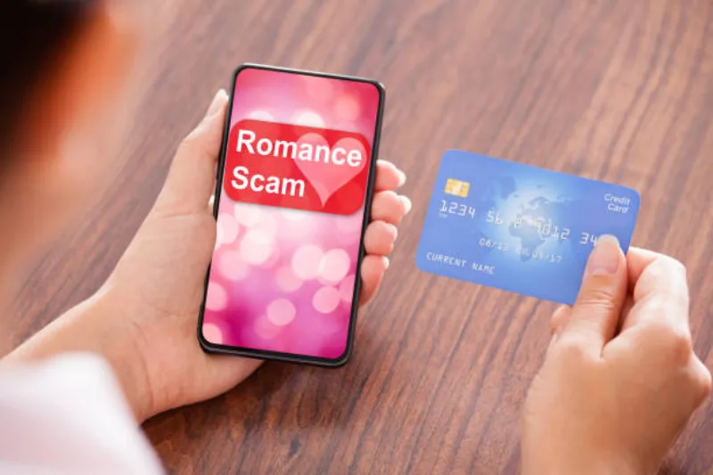 Close-up Of Businesswoman Paying With Credit Card On Mobile Phone