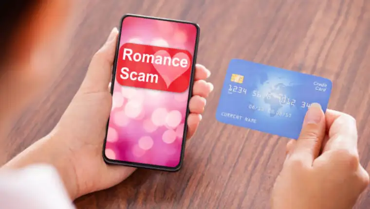 Close-up Of Businesswoman Paying With Credit Card On Mobile Phone