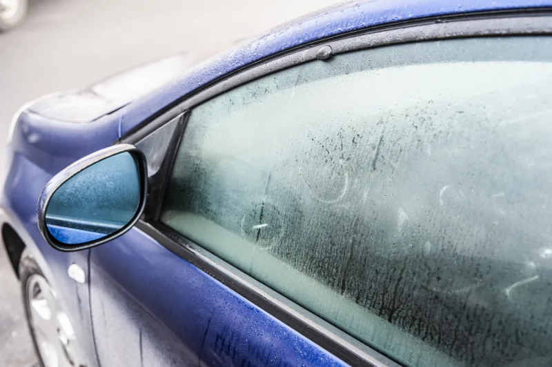 Steamy car window on a autumn rainy/foggy day. Concept of safety driving problem