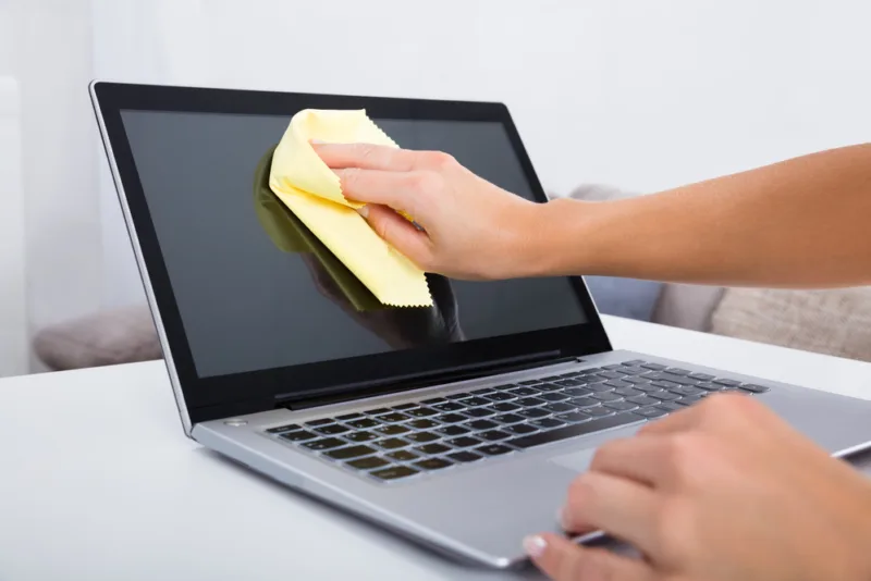 Woman Hand Cleaning Laptop Screen