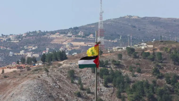Palestinian and Hezbollah flags flutter in Khiam, near Lebanon's border with Israel
