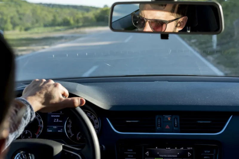 anonymous-male-traveling-with-car-sunny-day