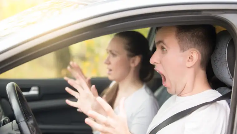 Young scared man driver and a woman passenger