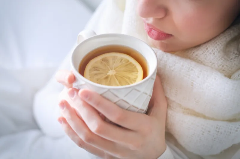 Young,Ill,Woman,Drinking,Hot,Tea,With,Lemon,At,Home,