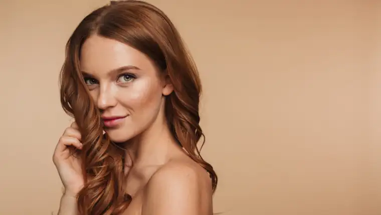 Beauty portrait of mystery smiling ginger woman with long hair